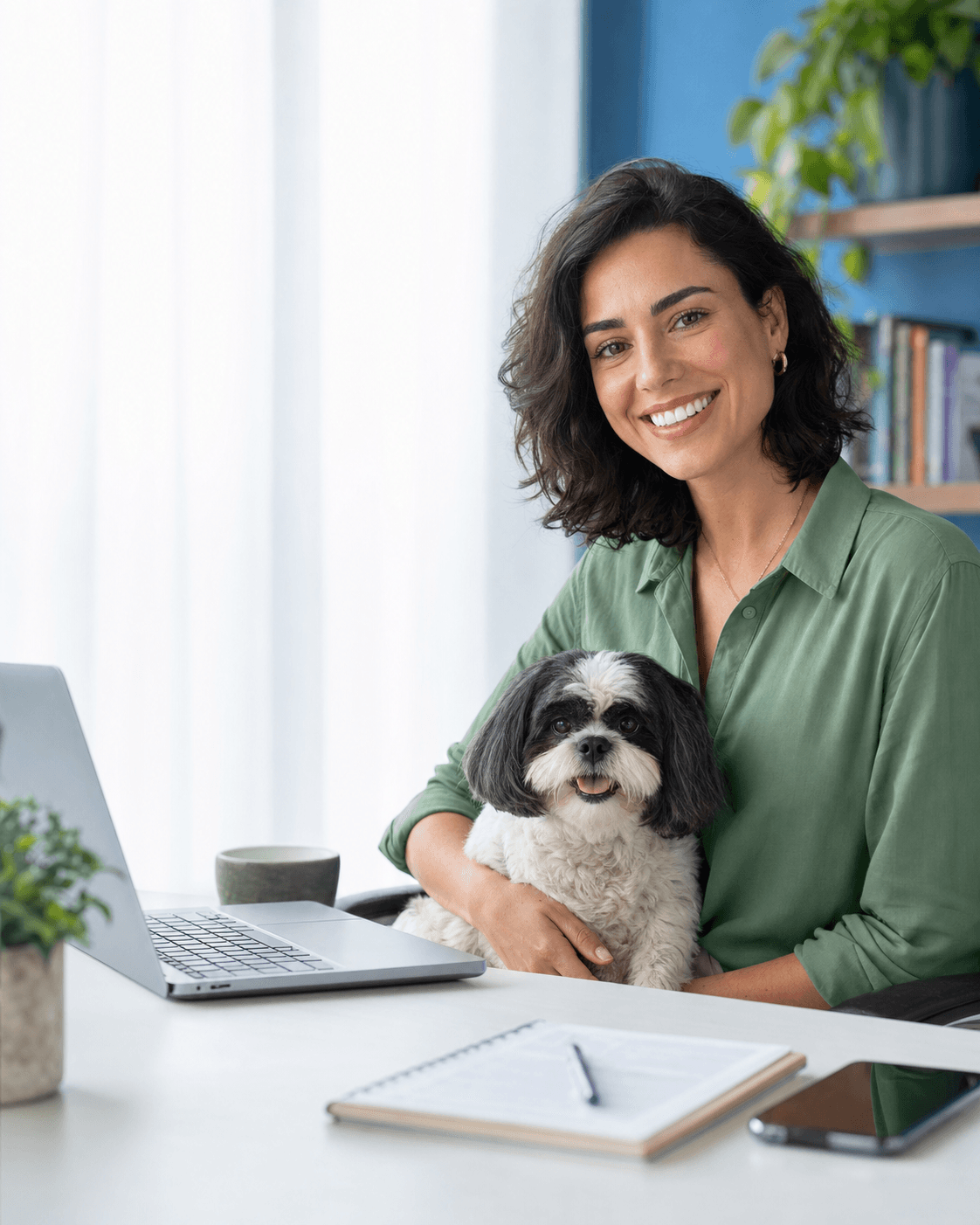 Mulher sorrindo com seu cachorro ao lado de um computador